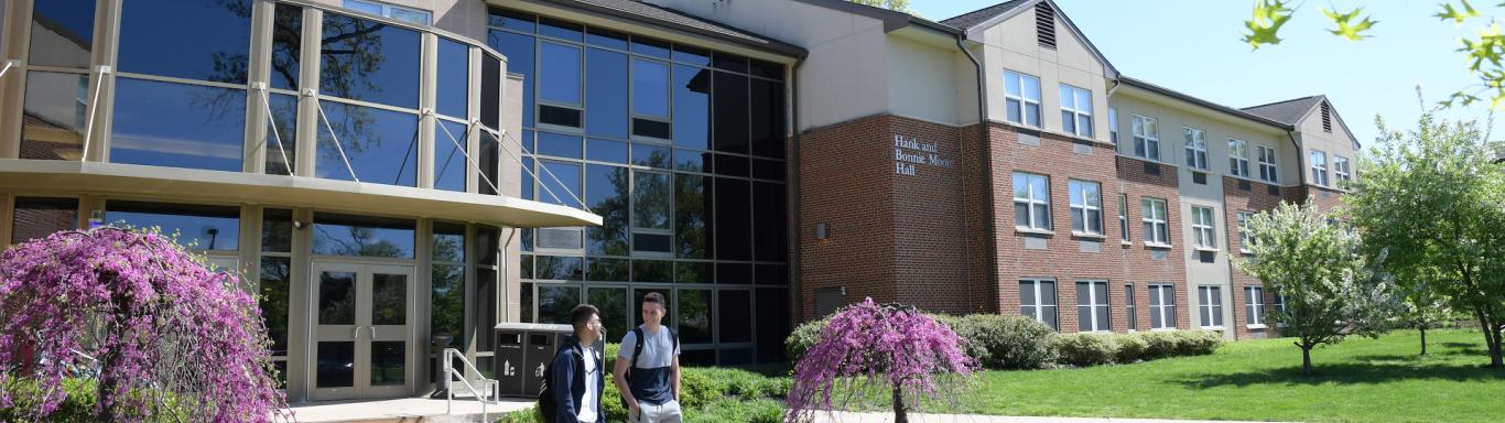 Students walk outside of Rider dorms.