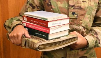 Military student holds books