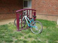 eco_bikeracks.jpg photo of a bicycle parked in a rack