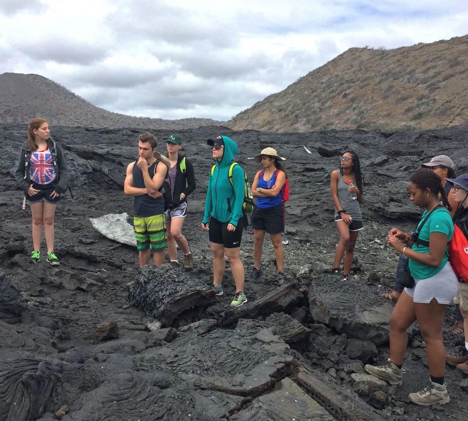 Students standing on volcanic ash in the galapagos
