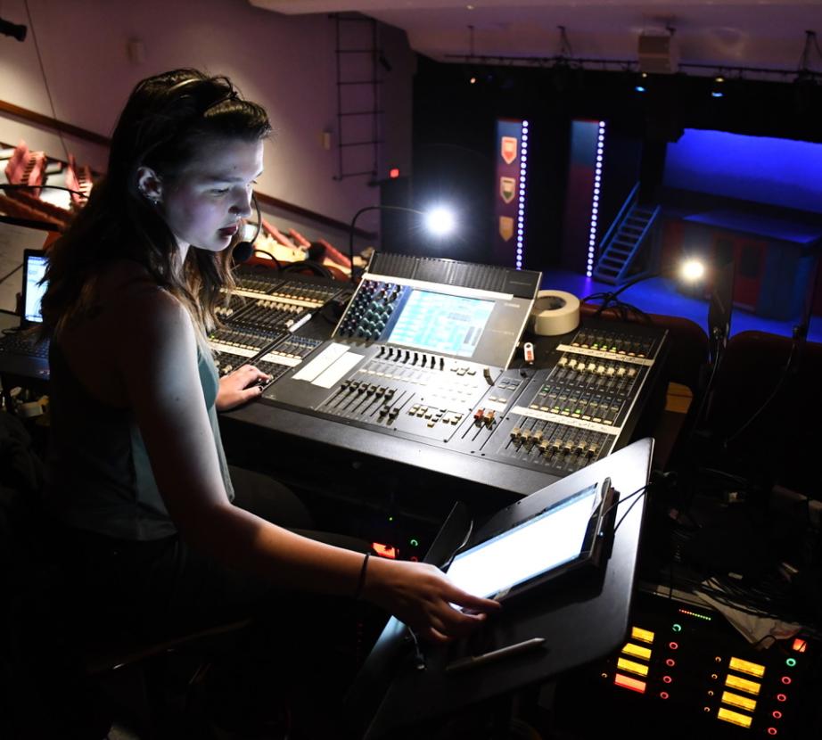 Student works on lighting board for show