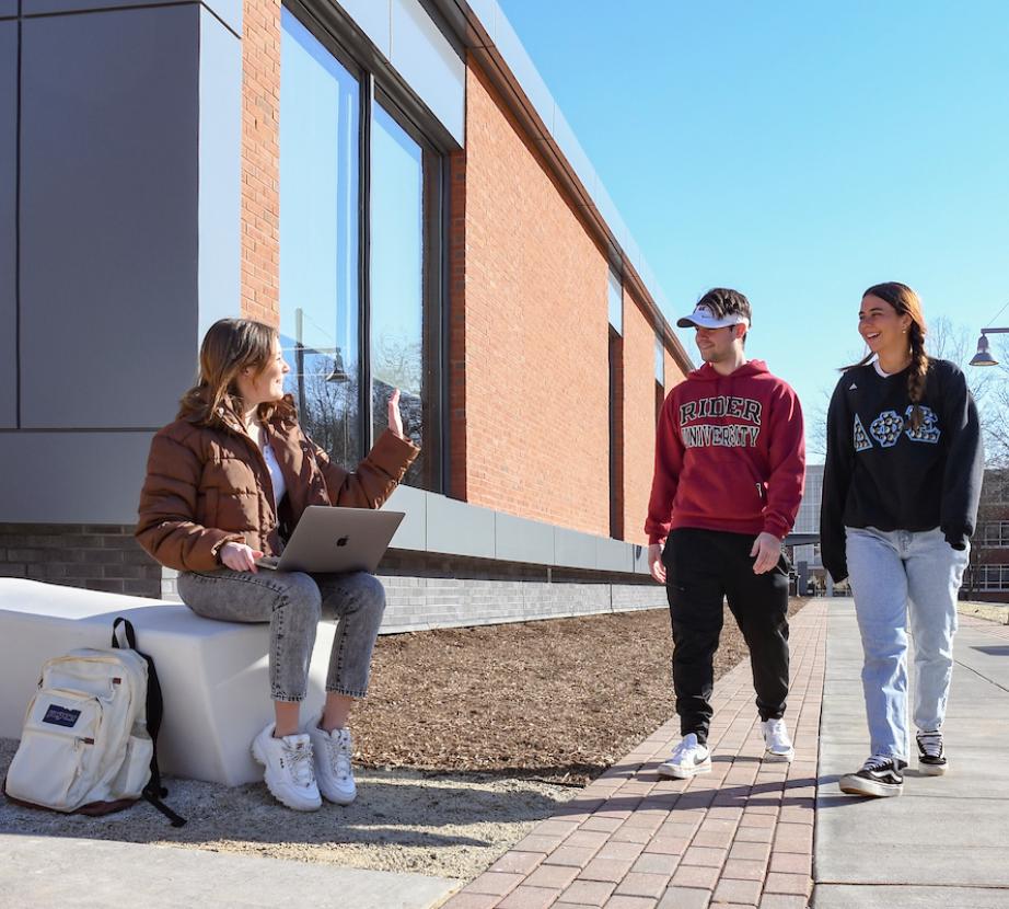 Students converse outside the Science and Technology Center entryway