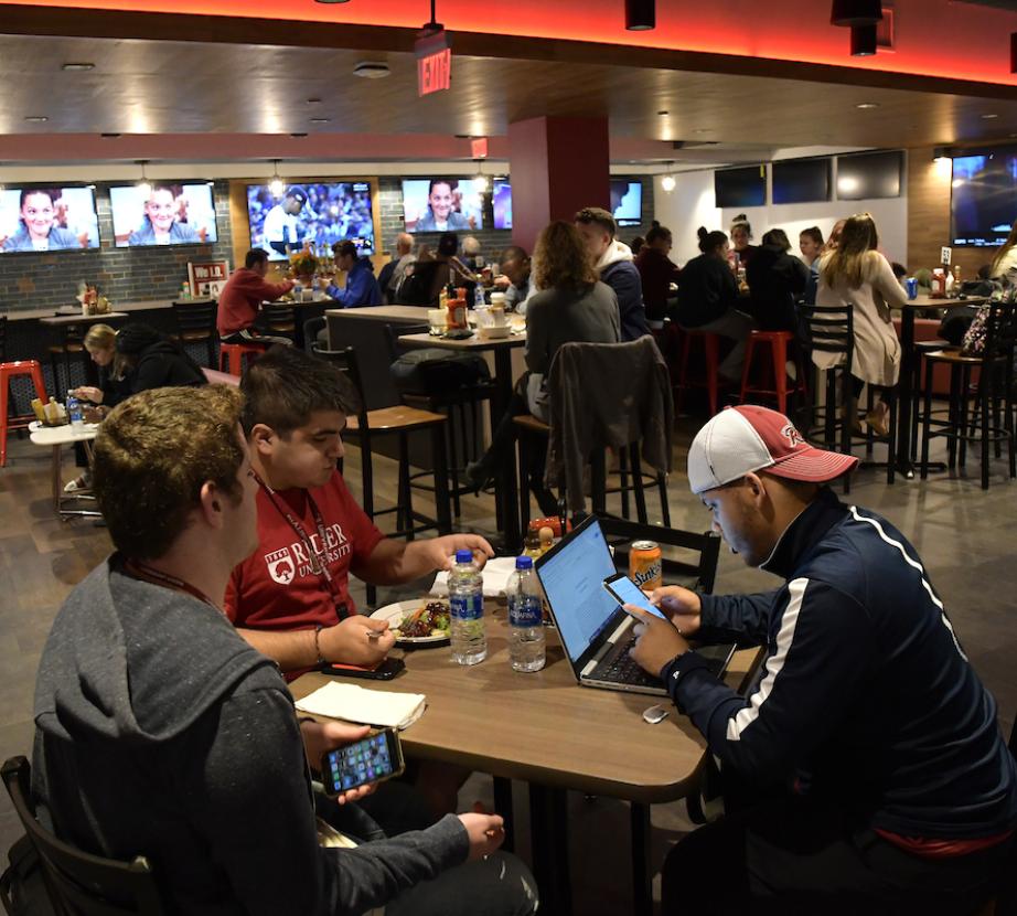 Students converse in Rider Pub