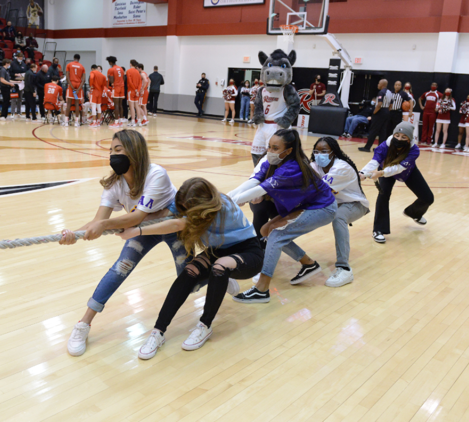 National Panhellenic Council students play tug-of-war in basketball court