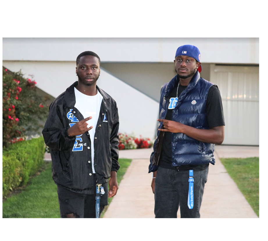 National Pan-Hellenic Council students hold up hand signals