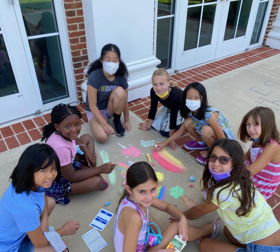 Piano camp students making chalk art