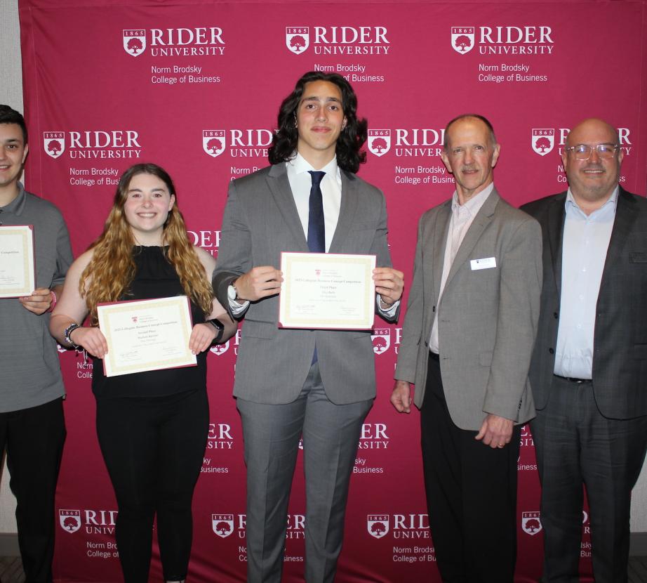 Three student and two faculty members pose for photo at Norm Brodsky Business Concept competition