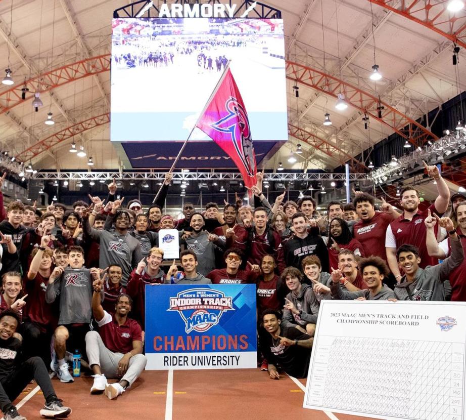 Men's track and field pose for photo after winning MAAC championship