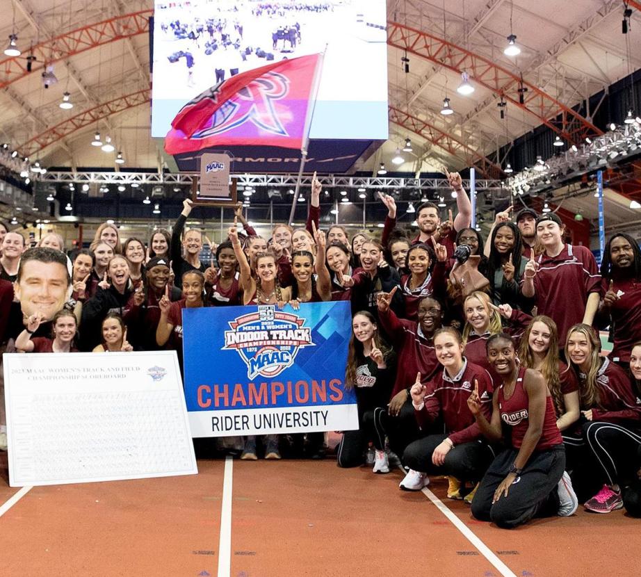 Women's track and field team poses as a group after winning MAAC championship