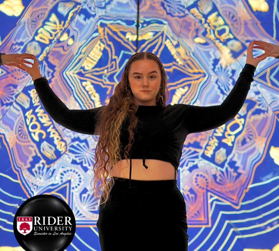 Student in front of wall art in Grand Central Market LA