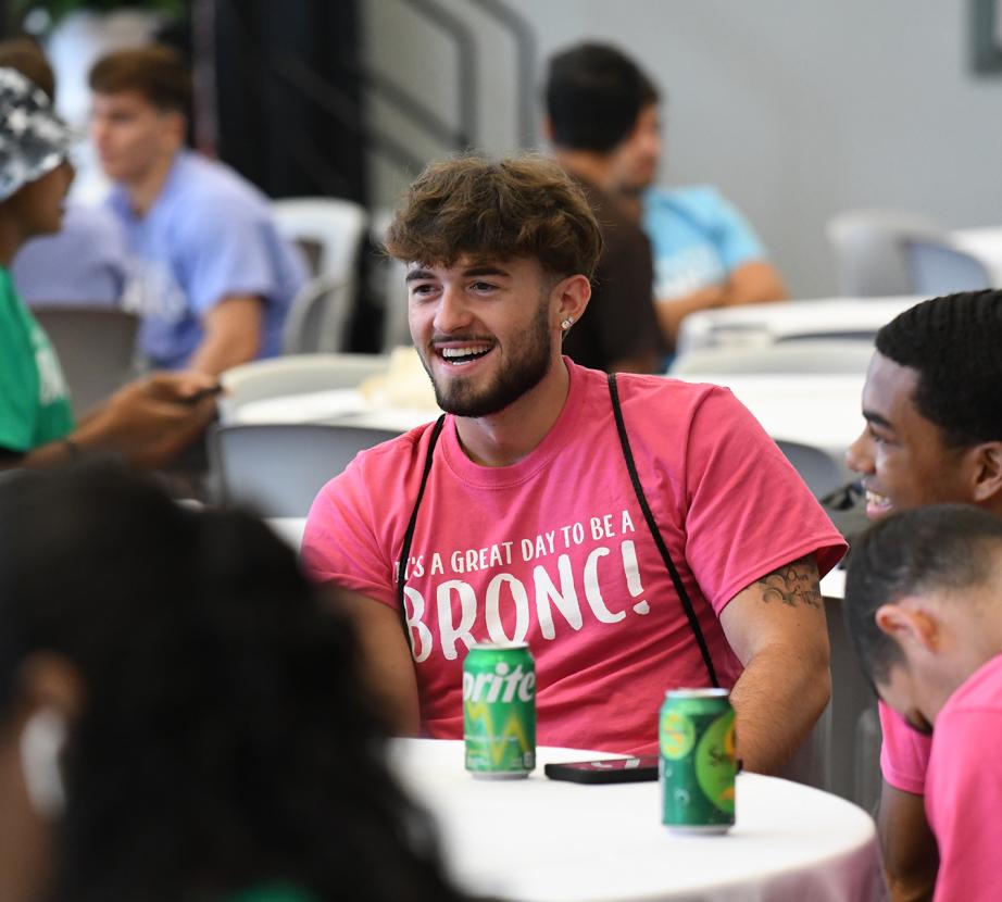 Students laughing at a table at New Student Orientation