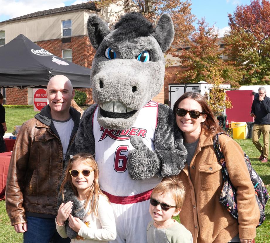 AJ takes a picture with a family