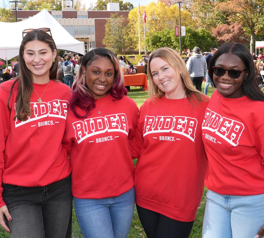 Group of girls in Rider shirts pose