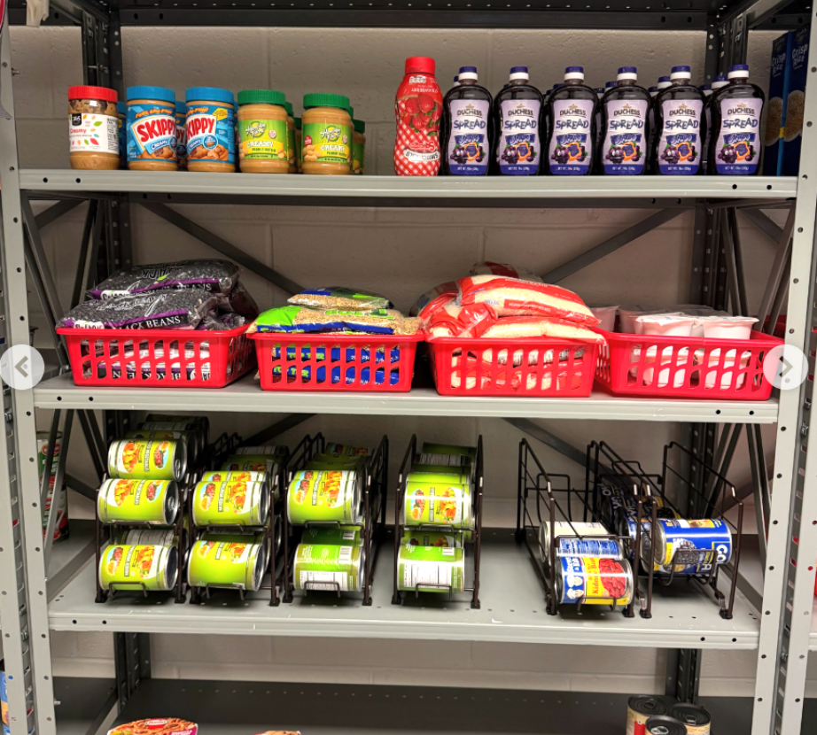 Shelves in the pantry featuring peanut butter, jelly, beans and other food items