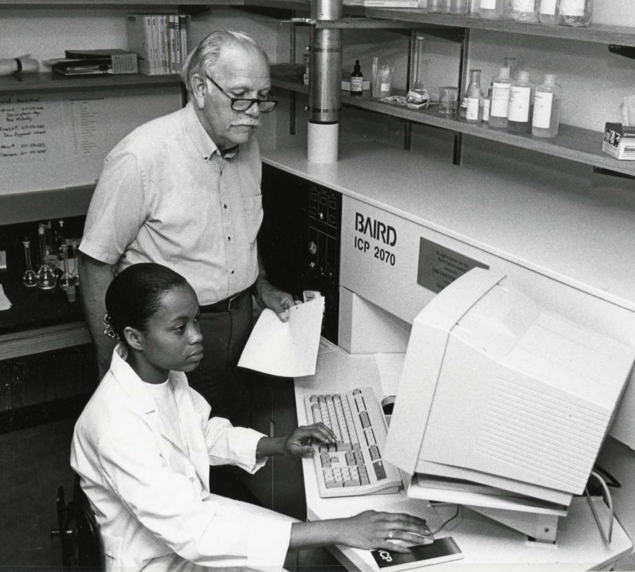 Old photo of two people in an office