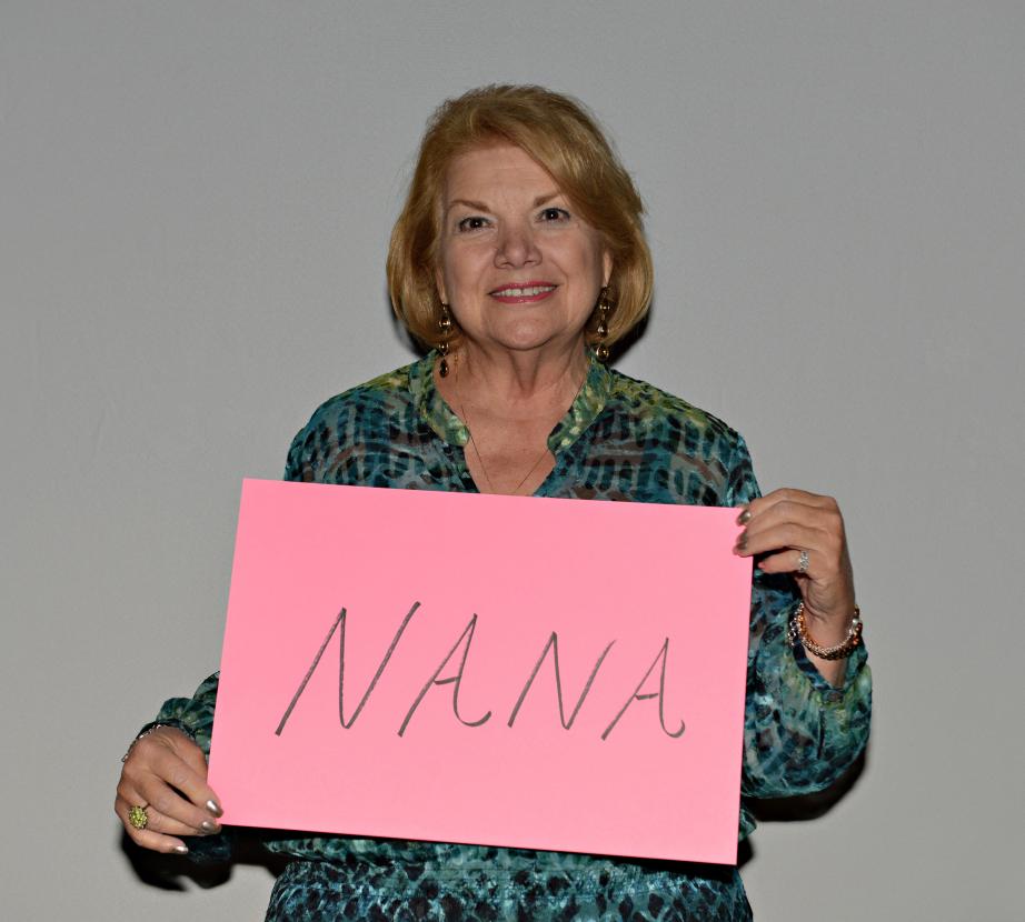 Woman holding sign saying "Nana"