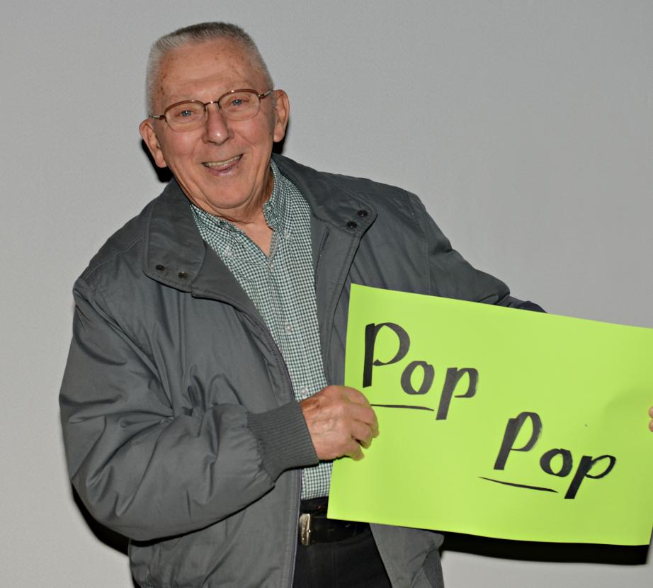 Man holding sign saying "Pop pop"