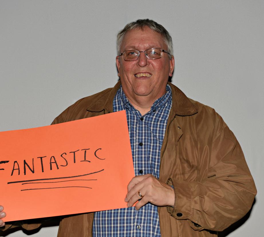 Man holding sign saying "Fantastic"