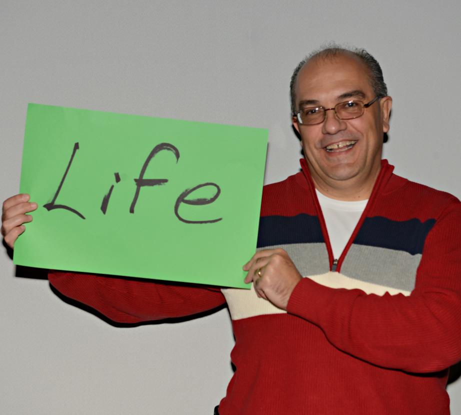 Man holding sign saying "Life"