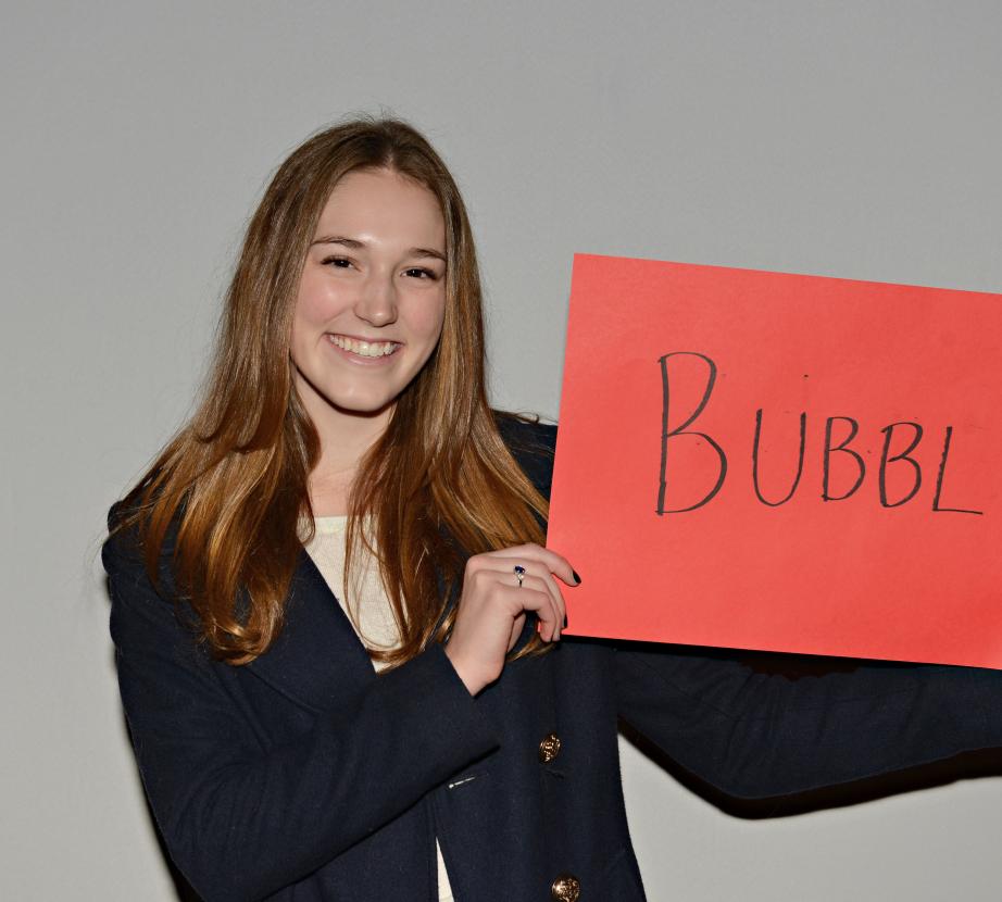 Girl holding sign saying "Bubbly"