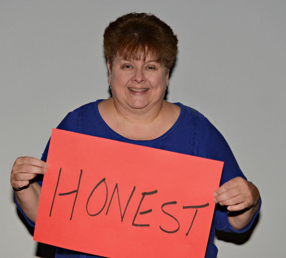 Woman holding sign saying "Honest"
