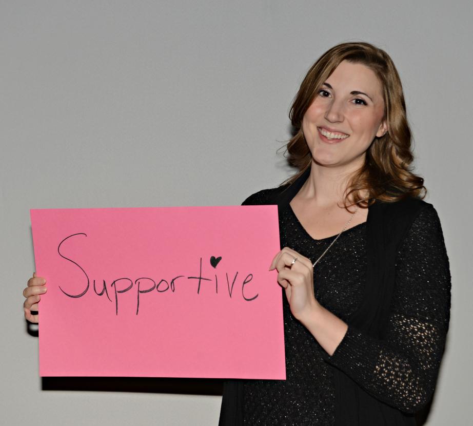 Woman holding sign saying "Supportive"