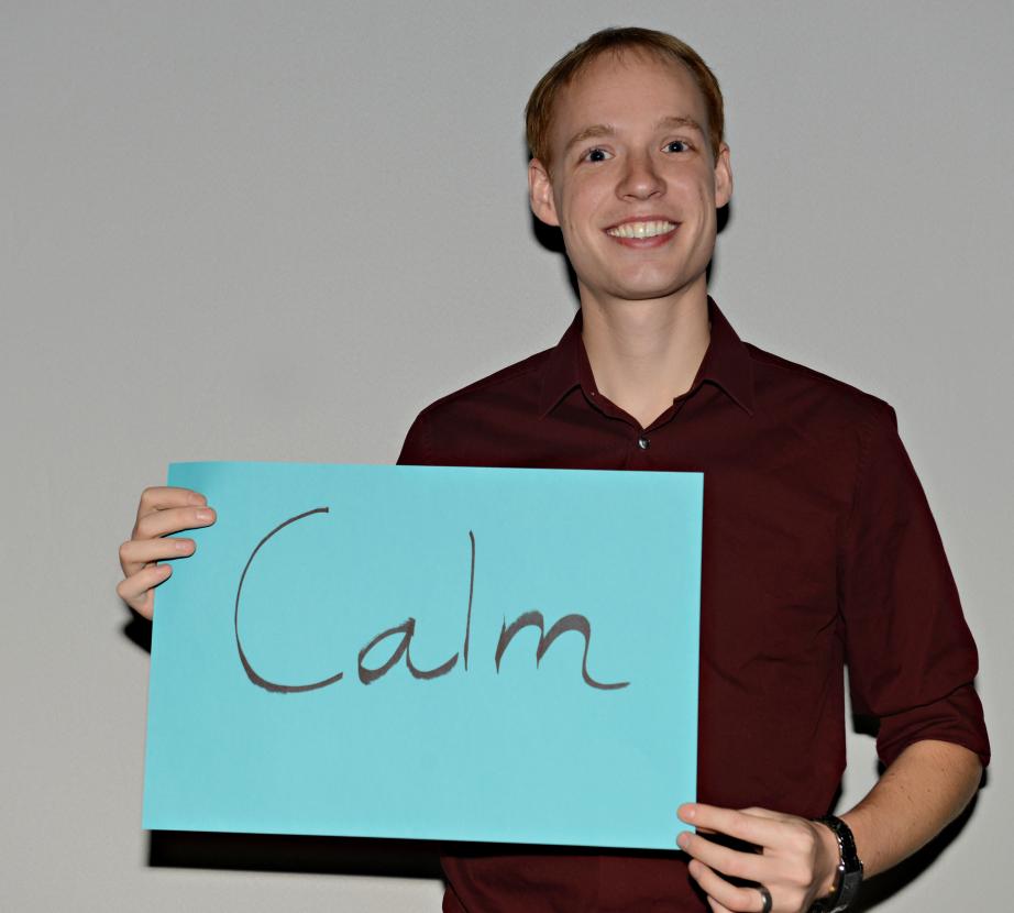 Man holding sign saying "Calm"