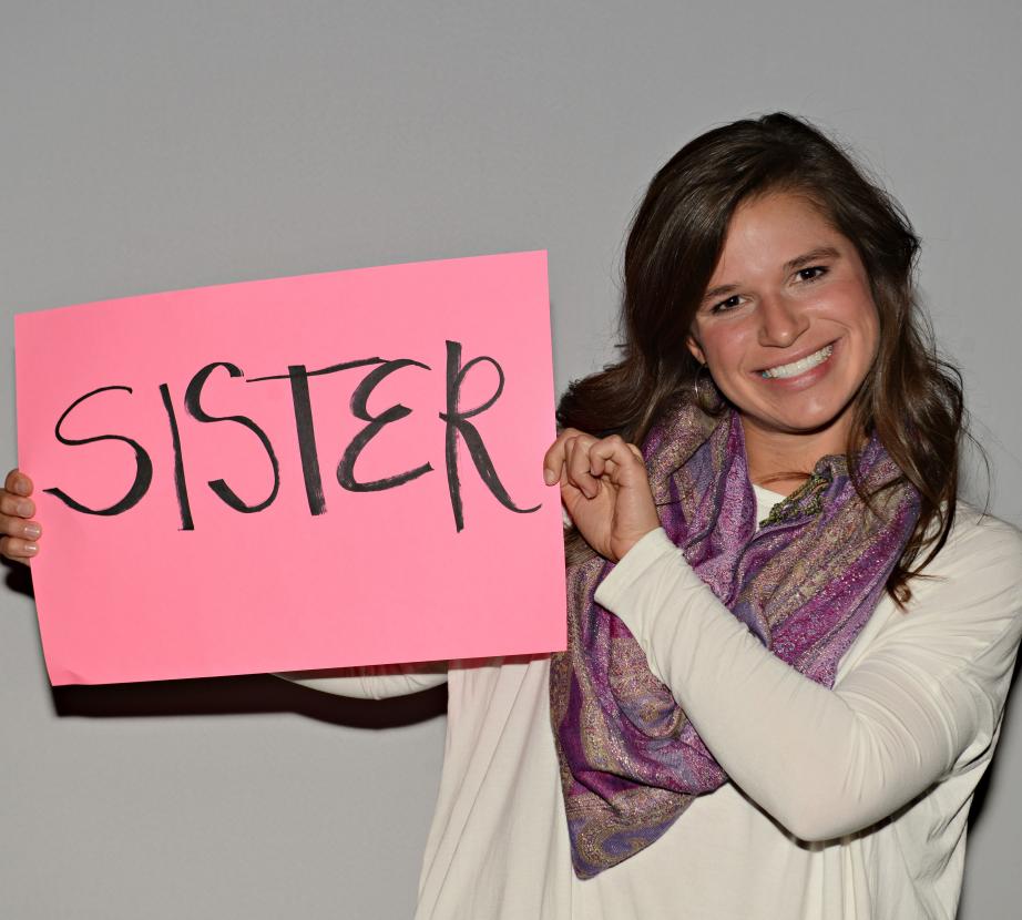 Woman holding sign saying "Sister"