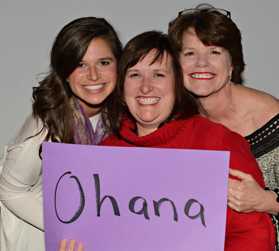 Three women hold sign that says "Ohaha"