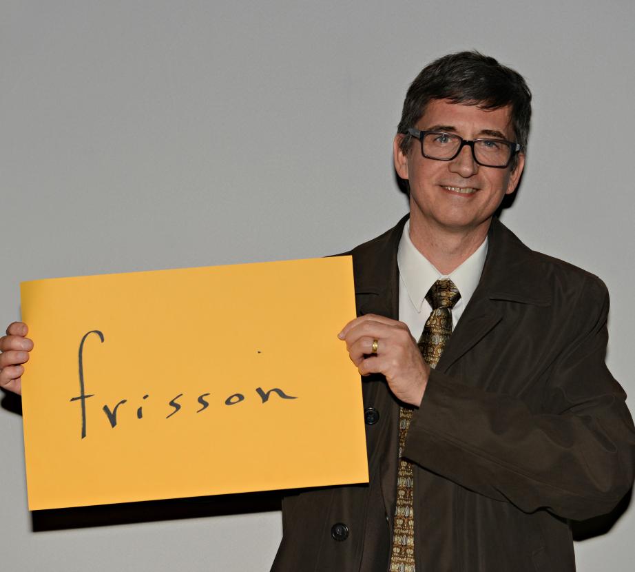 Man holding sign saying "frisson"