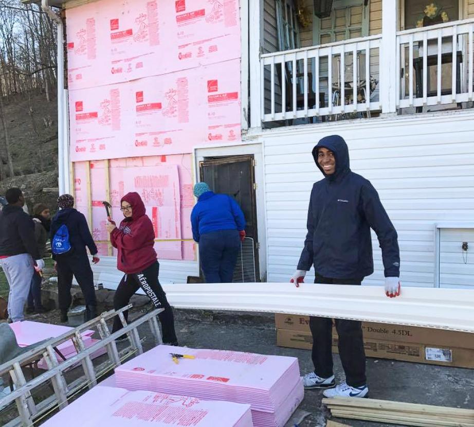 Students work on repairing house together.