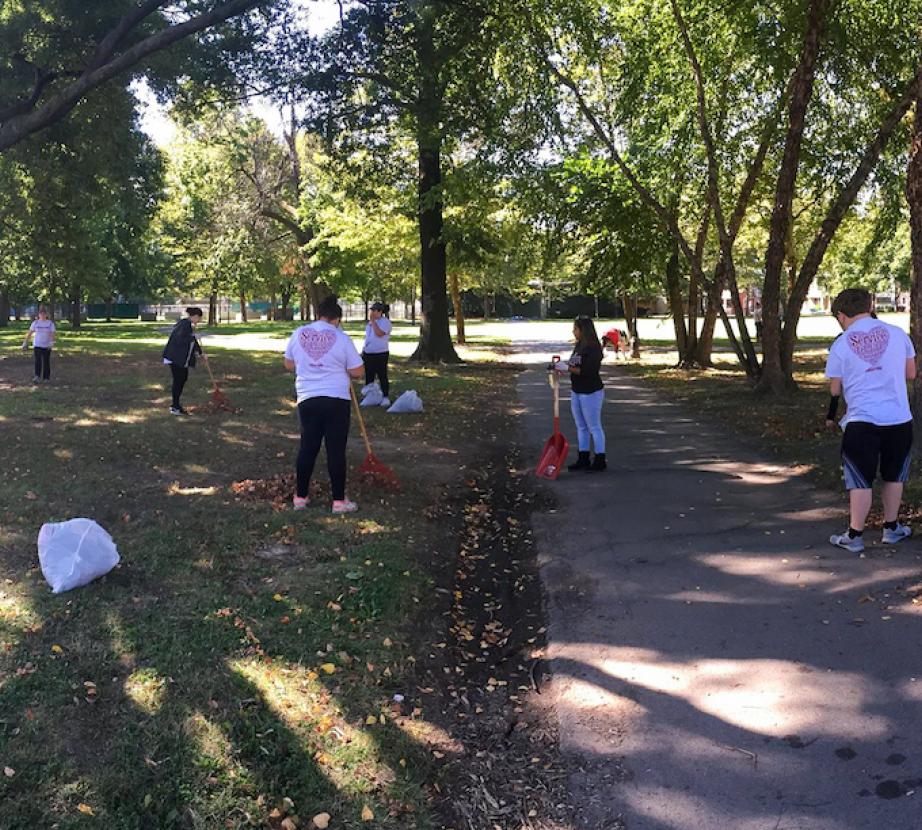 Students do yardwork outside.