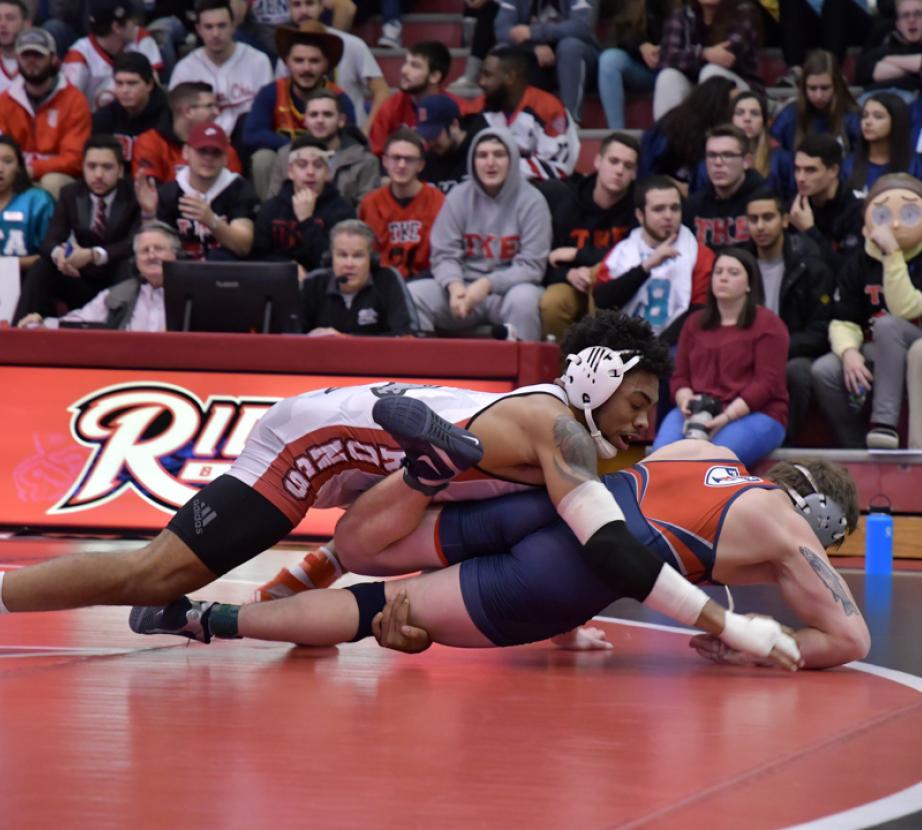 Wrestlers wrestle at Rider game.