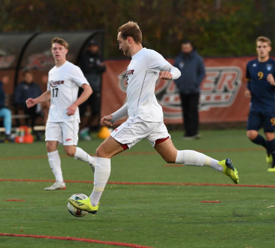 Soccer player kicks soccer ball.