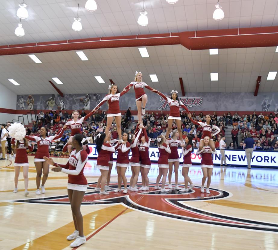 Cheerleaders cheer at basketball game.