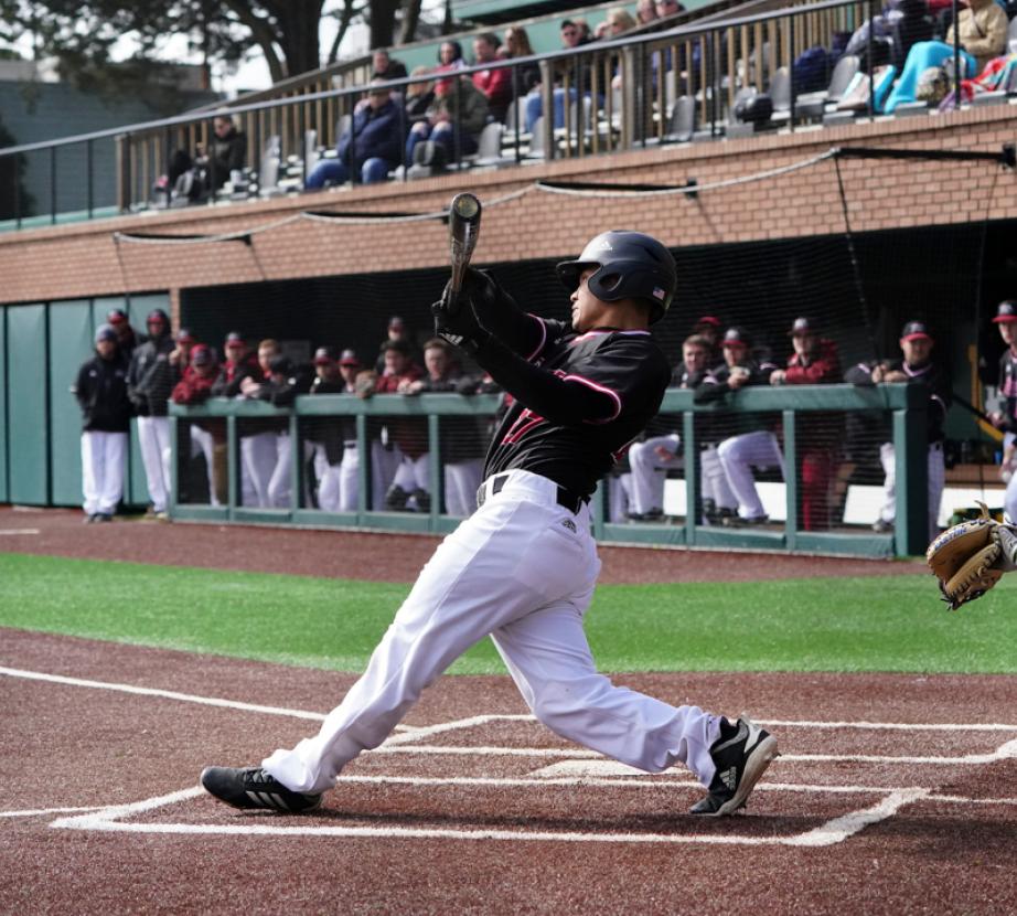 Baseball player hits baseball.