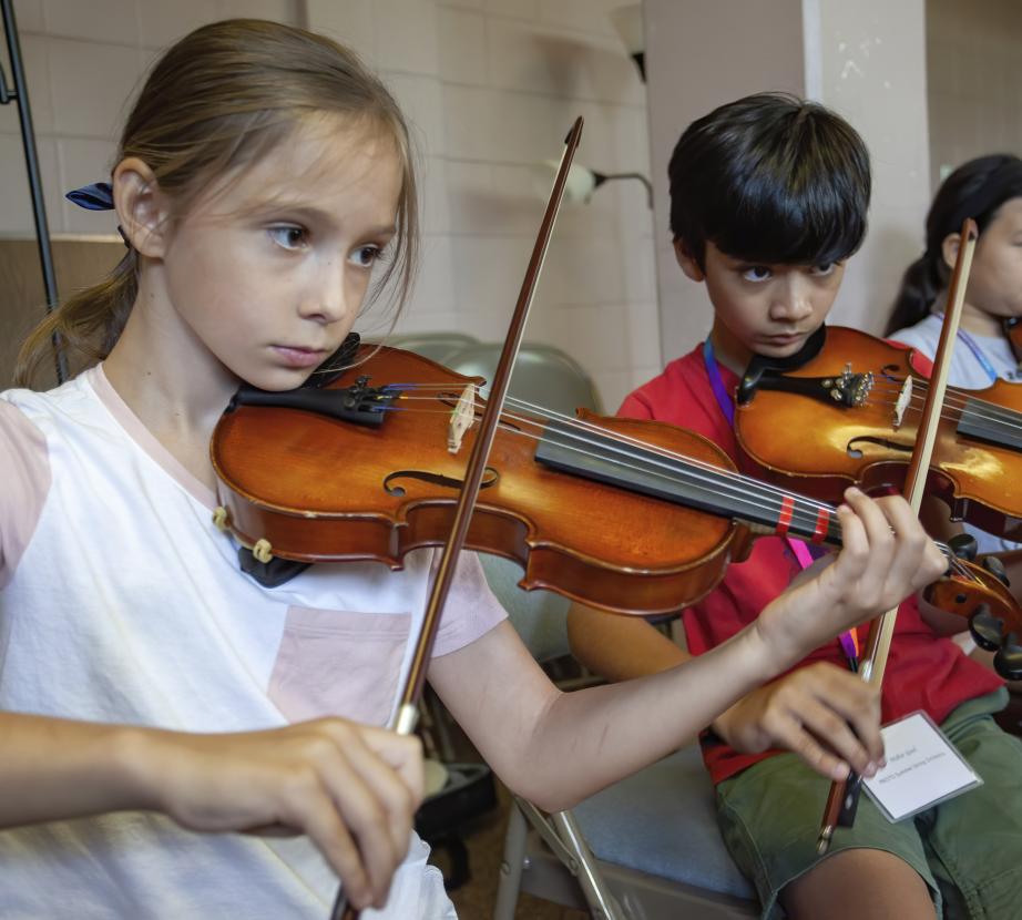 Student playing violins