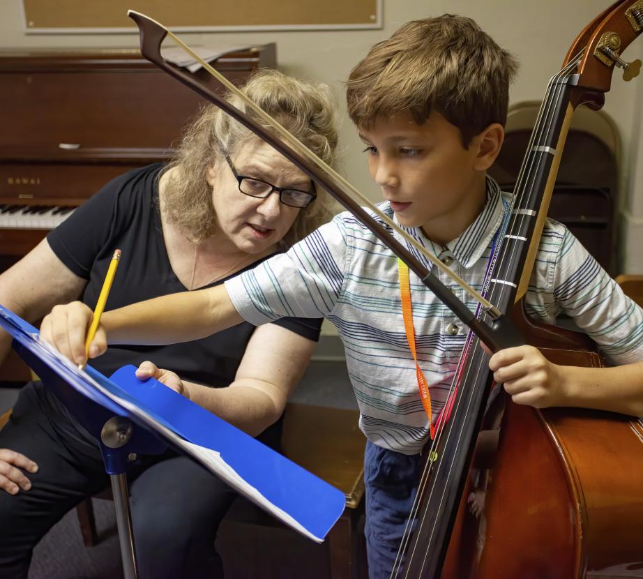Teacher working with a cello student