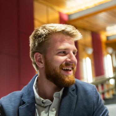 Student smiling with a business suit on