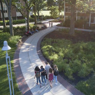 A group of students walking across campus
