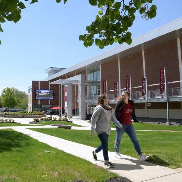 Students walk in front of Bart Luedeke Center