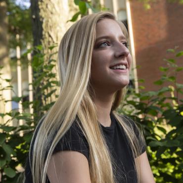 Student with long hair looks across campus