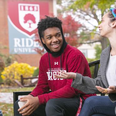 Students sit outside on campus