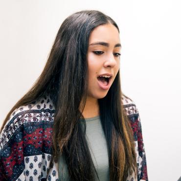 Young woman practices singing