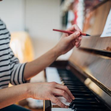 Student makes notation on music sheet