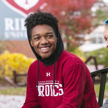 Two students smile and laugh