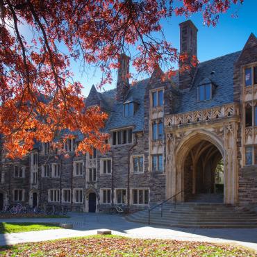 Large building in historic Princeton with fall leaves.