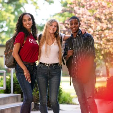 Three students pose for photo on Rider campus.