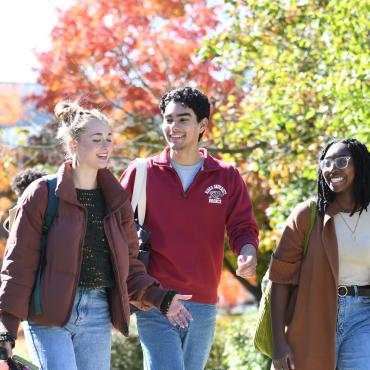 Students walking campus in the fall