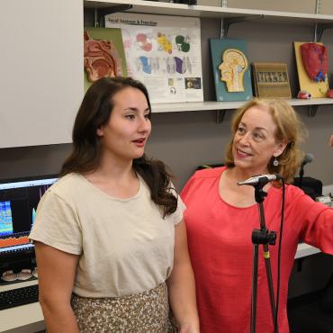 Kathy Price in presser voice lab with student.